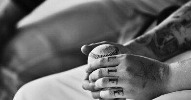grayscale photography of person holding baseball ball